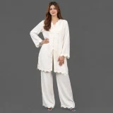 Close up of bow tie neckline and scalloped cuff detail on off white georgette co ord set