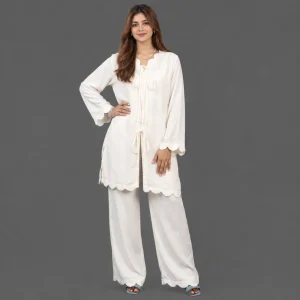 Close up of bow tie neckline and scalloped cuff detail on off white georgette co ord set